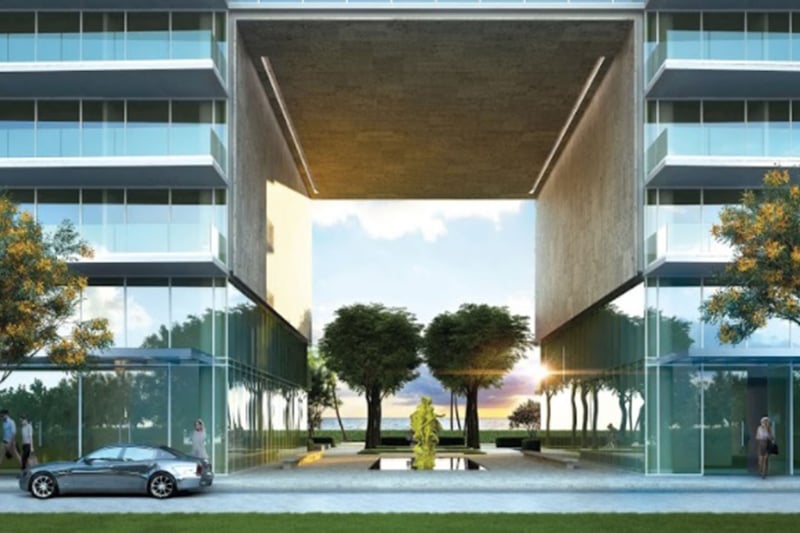 Grand condo entrance framed by twin towers, a reflecting pool and sculpture at Oceana Bal Harbour in Bal Harbour, Florida, setting a memorable luxury arrival for these ultra luxury condos.