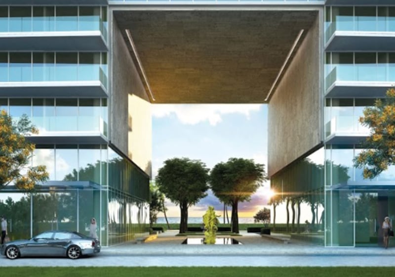 Grand condo entrance framed by twin towers, a reflecting pool and sculpture at Oceana Bal Harbour in Bal Harbour, Florida, setting a memorable luxury arrival for these ultra luxury condos.