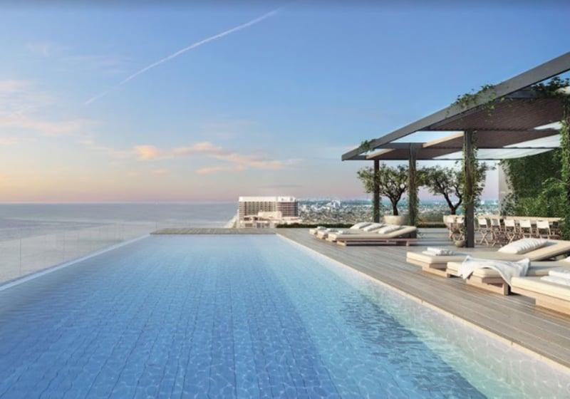 Infinity pool terrace with sun loungers, pergola seating and open water views at Oceana Bal Harbour in Bal Harbour, Florida, capturing the resort style luxury of these ultra luxury condos.
