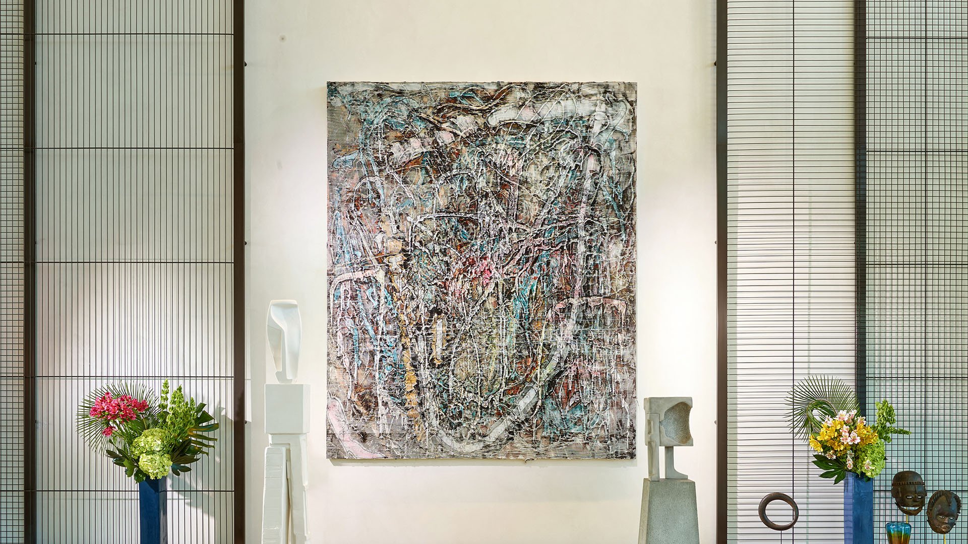 Lobby art gallery wall with a large abstract canvas and floral accents at Oceana Bal Harbour in Bal Harbour, Florida, reflecting the curated luxury aesthetic found throughout these ultra luxury condos.
