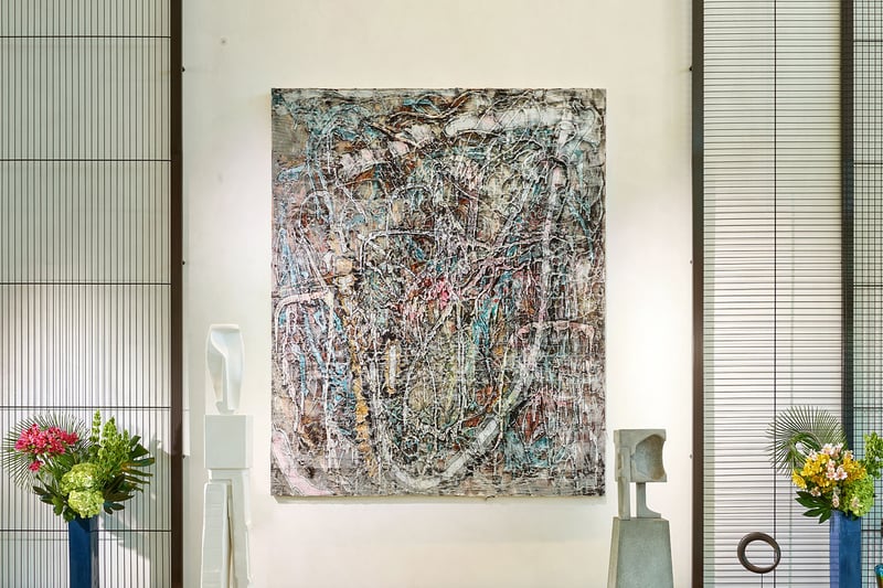 Lobby art gallery wall with a large abstract canvas and floral accents at Oceana Bal Harbour in Bal Harbour, Florida, reflecting the curated luxury aesthetic found throughout these ultra luxury condos.