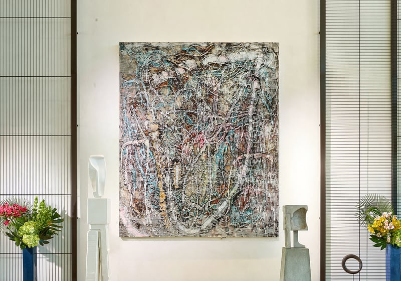 Lobby art gallery wall with a large abstract canvas and floral accents at Oceana Bal Harbour in Bal Harbour, Florida, reflecting the curated luxury aesthetic found throughout these ultra luxury condos.