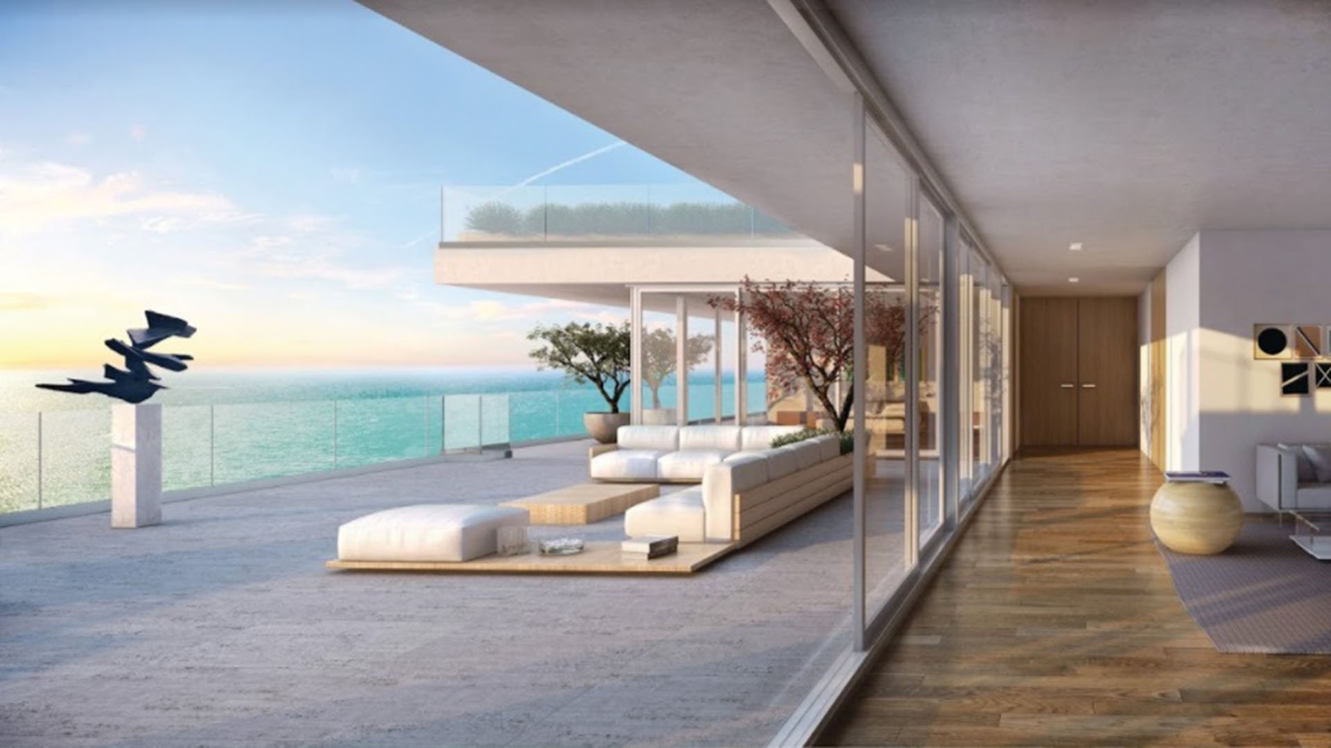 Oceanfront terrace lounge flowing beside floor to ceiling glass walls at Oceana Bal Harbour in Bal Harbour, Florida, showcasing the seamless luxury indoor outdoor living of these ultra luxury condos.