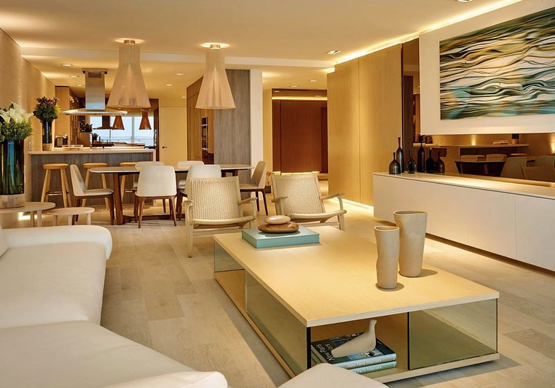 Open-plan living and dining room at Oceana Key Biscayne in Key Biscayne, presenting luxury and ultra luxury condos with warm lighting, modern furnishings, dining space, and a connected kitchen.