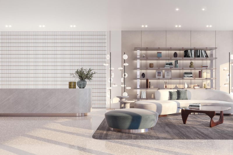 Onda Bay Harbor condominium lobby in Bay Harbor Islands, Miami, Florida with reception desk, curved sofa seating and designer bookshelf-luxury and ultra luxury preconstruction condos arrival experience.