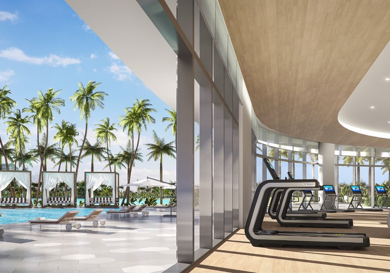 One Park Tower by Turnberry gym overlooking pool and palms in North Miami; luxury wellness amenity for ultra luxury preconstruction condos at SoLé Mia.