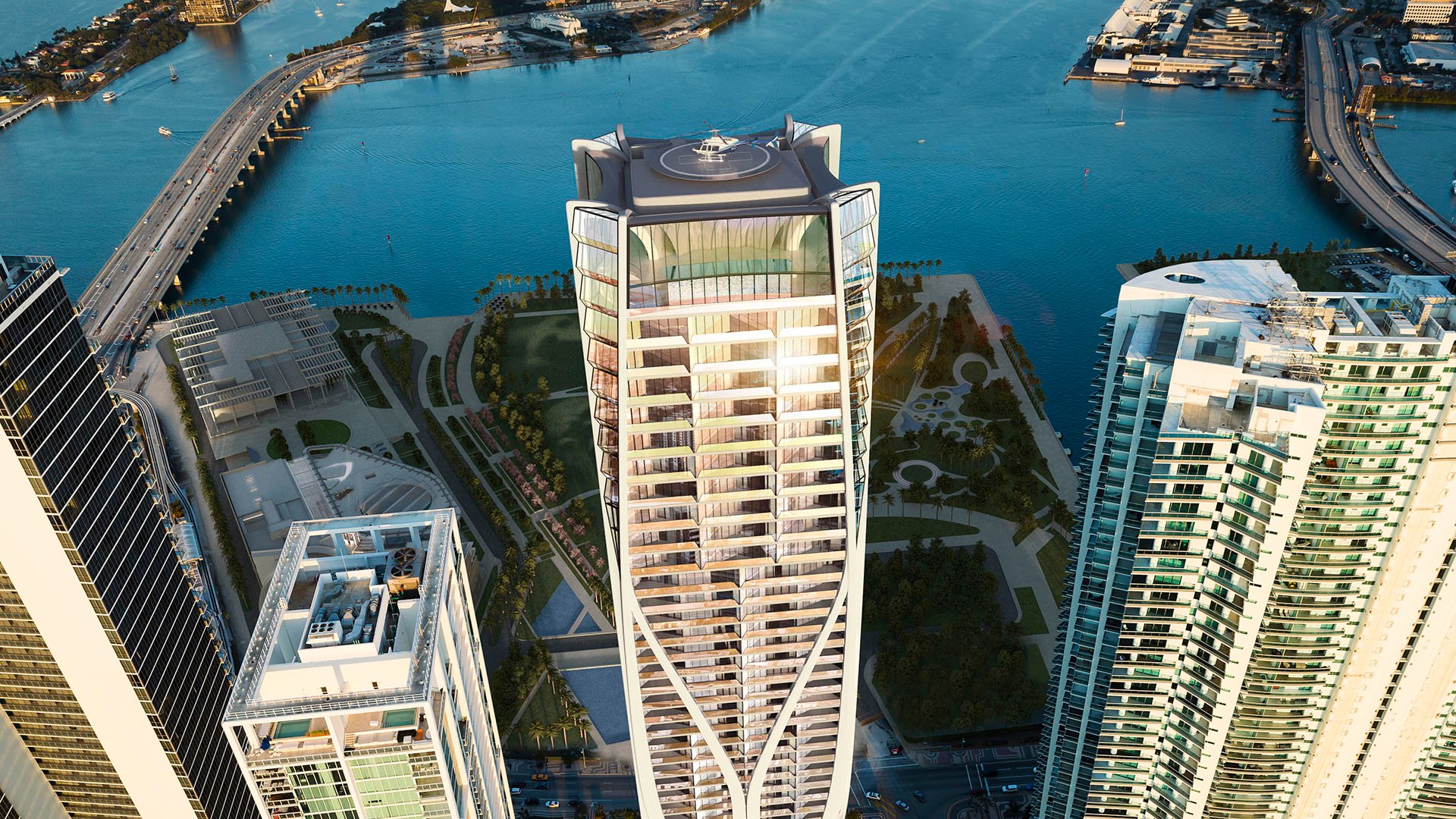 Top-down aerial of One Thousand Museum in Downtown Miami with the rooftop helipad, surrounding towers, and waterfront below, highlighting luxury and ultra luxury condos.