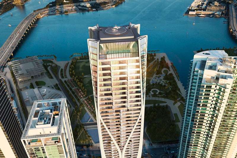 Top-down aerial of One Thousand Museum in Downtown Miami with the rooftop helipad, surrounding towers, and waterfront below, highlighting luxury and ultra luxury condos.