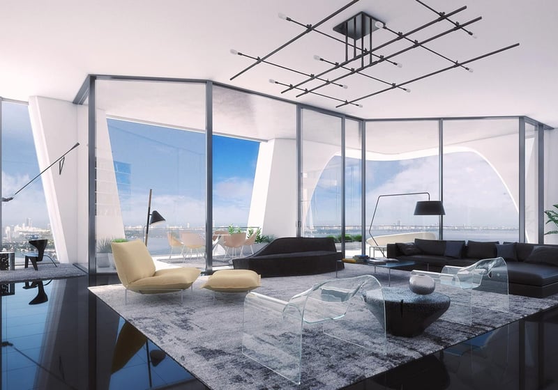 Open-plan living room at One Thousand Museum in Downtown Miami with a home office nook and broad waterfront views for luxury and ultra luxury condos.