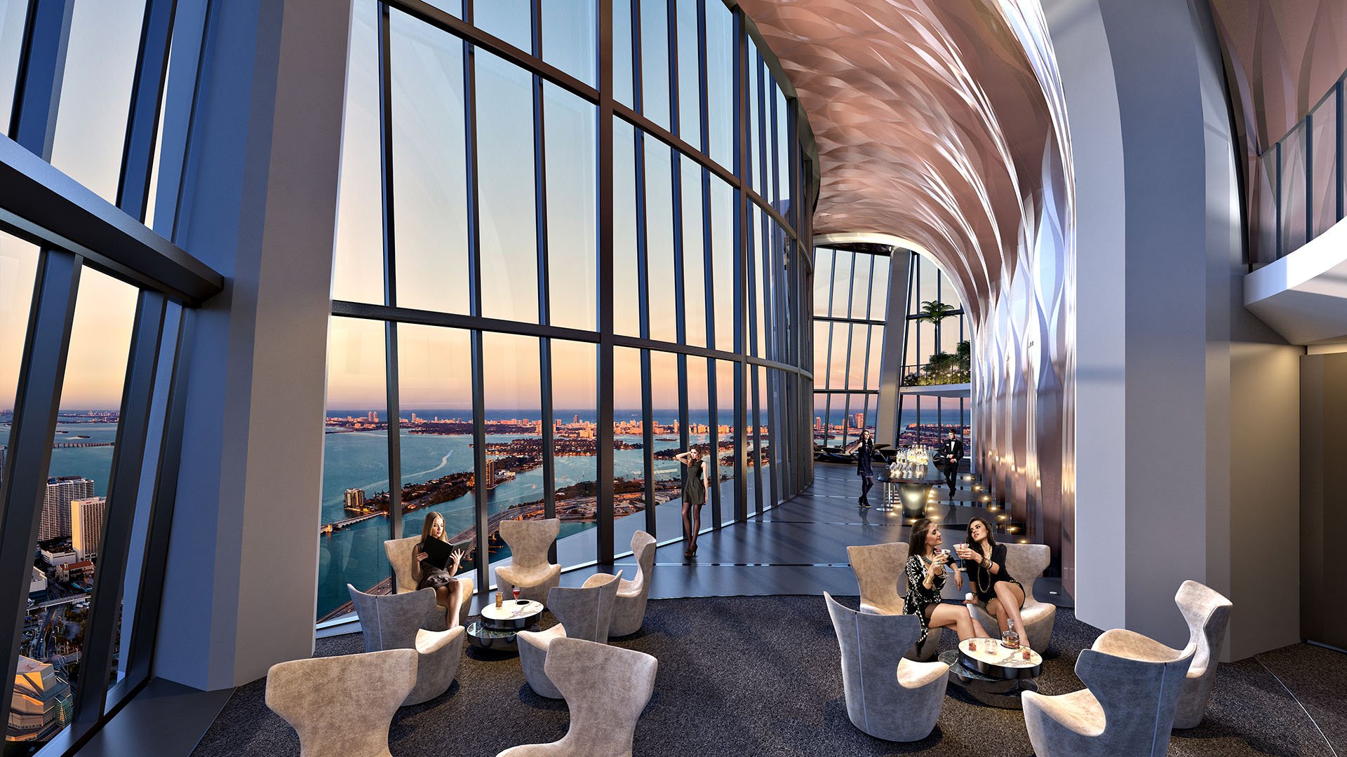 Sky bar lounge at One Thousand Museum in Downtown Miami with cocktail seating, a soaring glass wall, and sunset waterfront views for luxury and ultra luxury condos.
