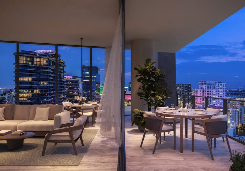 ORA by Casa Tua, Brickell Miami balcony dining with city lights, elevated lifestyle in luxury and ultra luxury condos; preconstruction. Featuring cityscape and evening.