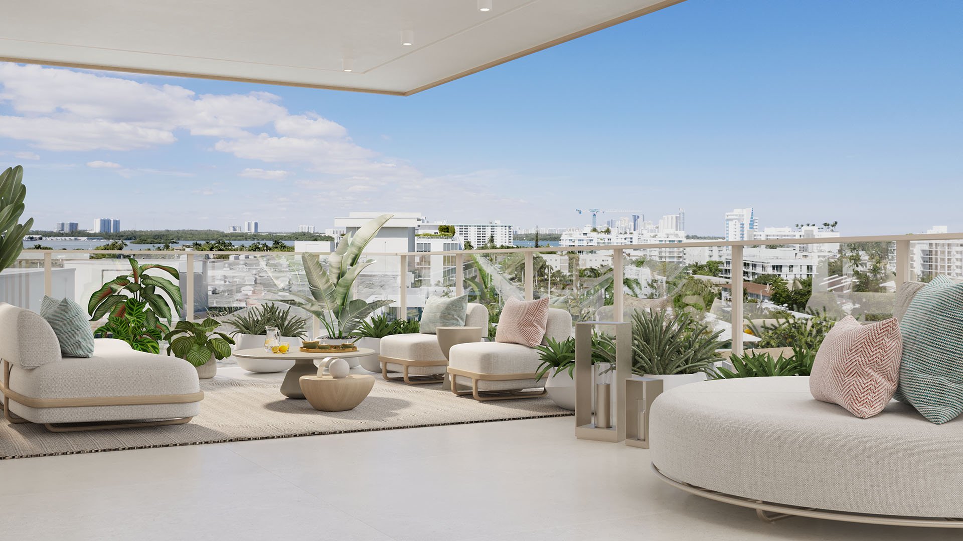 Origin Residences Bay Harbor Islands Unit 604 private terrace with outdoor lounge seating, tropical plants and glass railing overlooking Miami, Florida skyline, highlighting luxury and ultra luxury preconstruction condos.