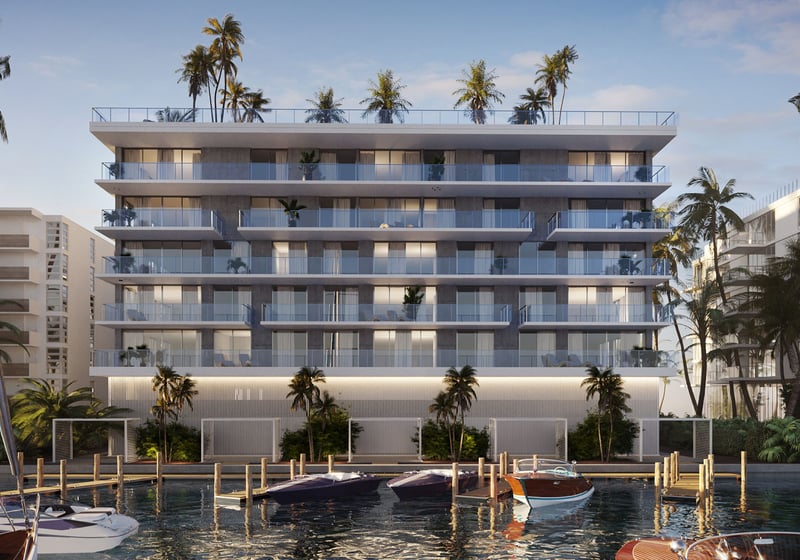 Golden hour view of Origin Residences Bay Harbor Islands waterfront exterior with boats docked, palm trees and glass balconies in Miami, Florida, showcasing luxury and ultra luxury preconstruction condos and marina living.