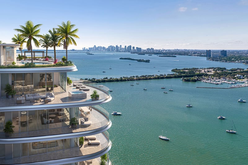Pagani Residences penthouse terrace in North Bay Village, Miami, Florida with curved glass balcony, daytime views of Biscayne Bay, islands, marina and Miami skyline; luxury and ultra luxury preconstruction condos.