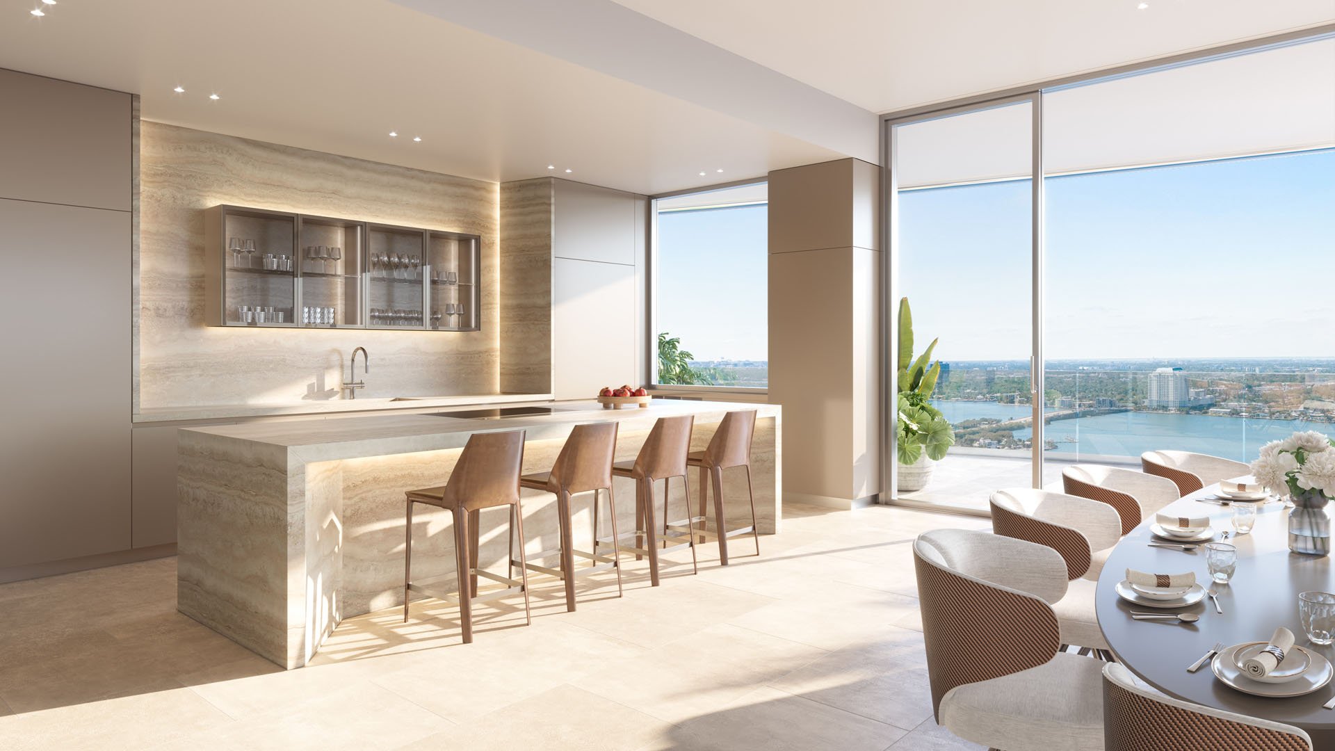 Pagani Residences North Bay Village Miami chef kitchen with travertine waterfall island, sleek lacquer cabinets, tile floors and floor-to-ceiling windows on Biscayne Bay, luxury and ultra luxury preconstruction condos.