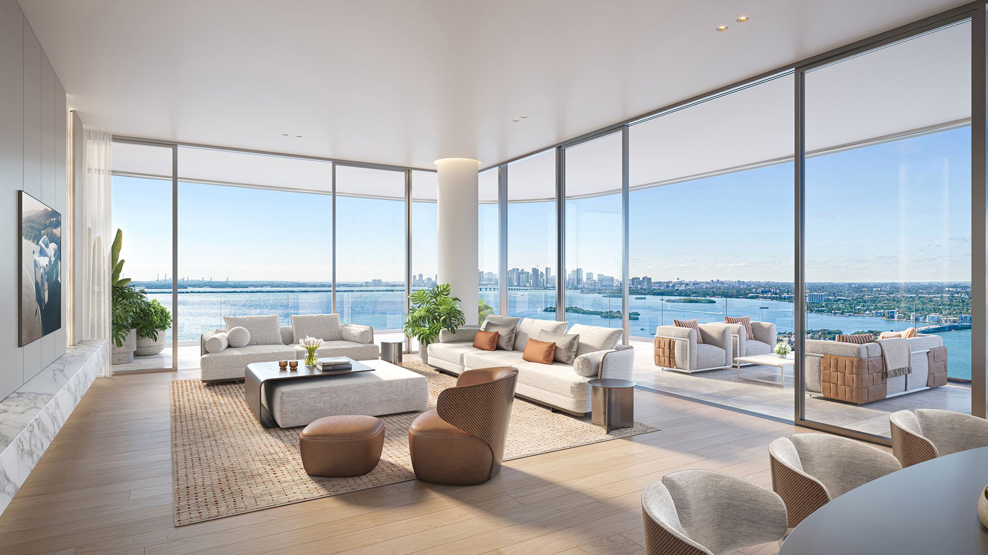 Pagani Residences North Bay Village Miami Residence 02 living room with curved glass walls, modern seating and sweeping Biscayne Bay and Miami skyline views, luxury and ultra luxury preconstruction condos.
