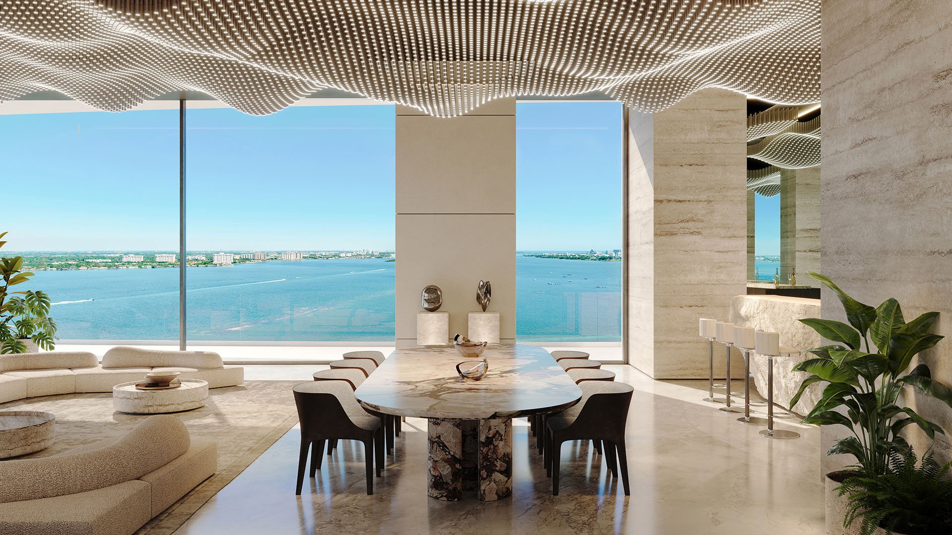 Pagani Residences sky lounge dining room in North Bay Village, Miami overlooking Biscayne Bay, with marble table, LED ceiling and waterfront bar, showcasing luxury and ultra luxury preconstruction condos lifestyle and amenities.