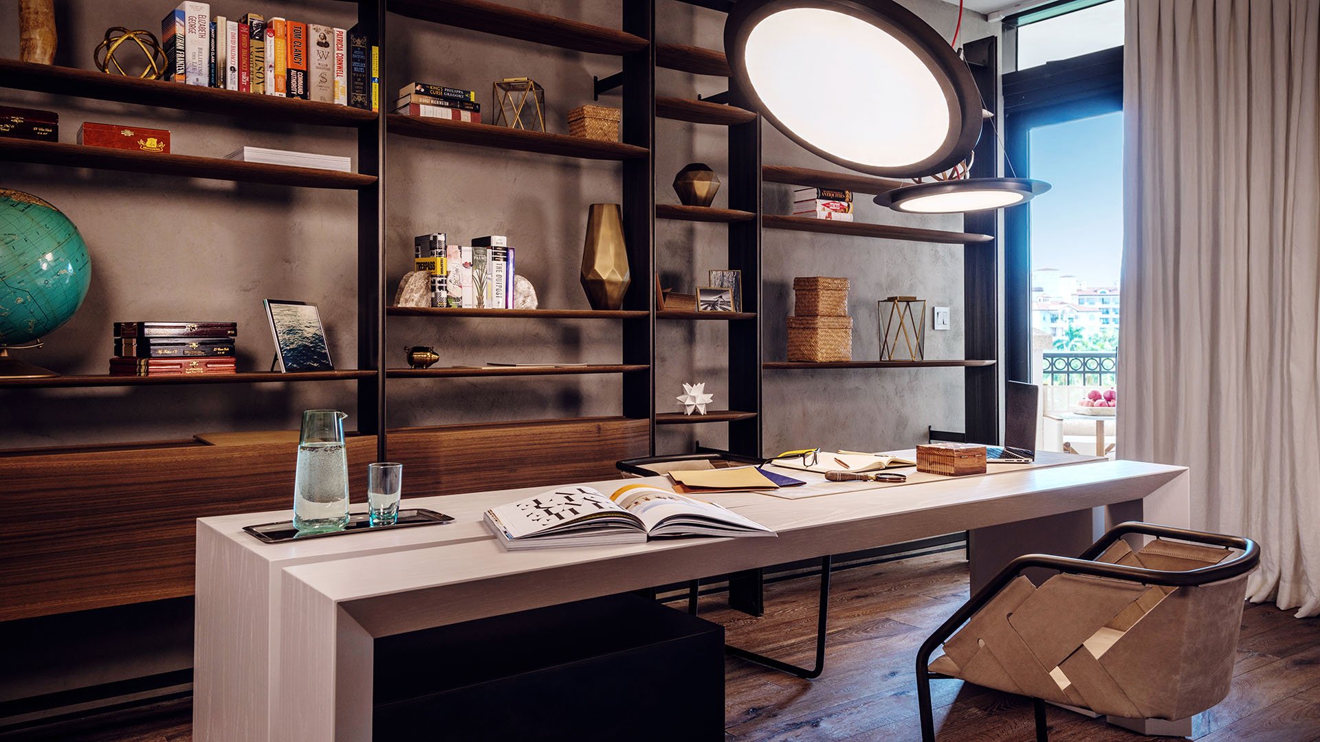 Home office at Palazzo del Sol, Fisher Island, highlighting luxury and ultra luxury condos with custom bookshelves, a large desk, warm wood finishes, and a city-facing window.