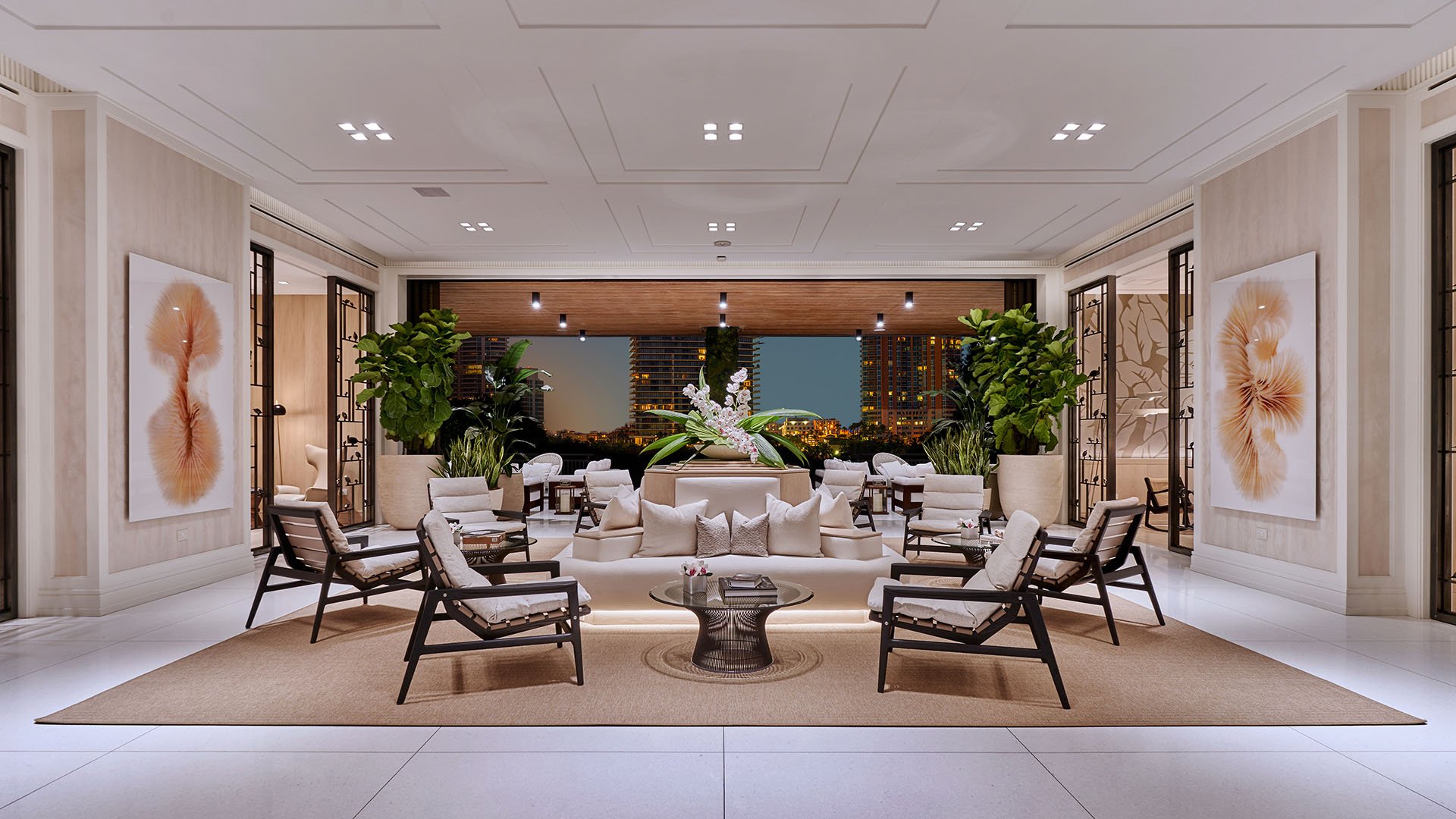 Palazzo della Luna in Fisher Island luxury and ultra luxury condos with a grand lobby seating hall, symmetrical furniture placement, and refined stone finishes.