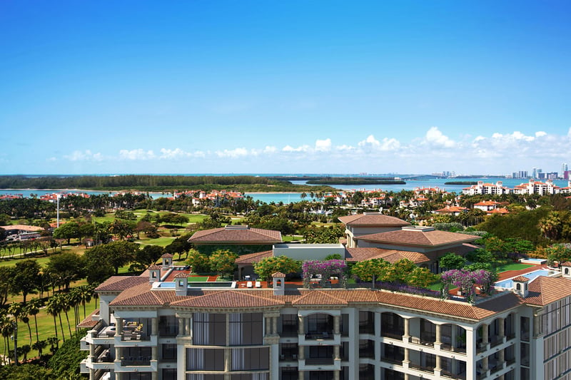 Palazzo della Luna in Fisher Island luxury and ultra luxury condos with penthouse rooftop terraces overlooking the bay, gardens, and a distant skyline.