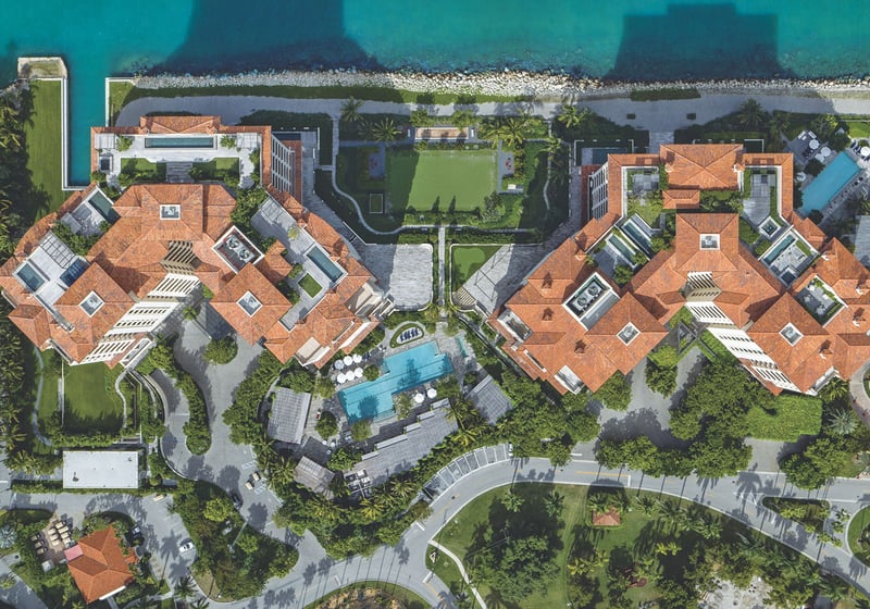 Palazzo della Luna in Fisher Island luxury and ultra luxury condos in a top-down aerial of the full waterfront complex, seawall, pool, and landscaped arrival drives.