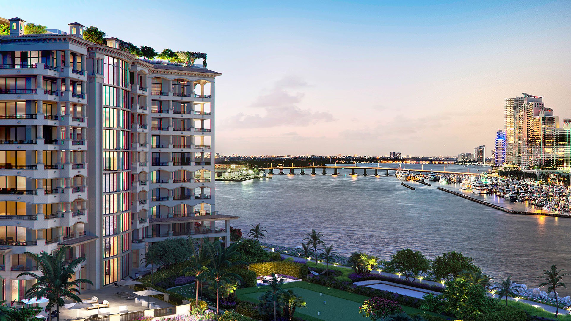 Palazzo della Luna in Fisher Island luxury and ultra luxury condos with a wide waterfront exterior view facing the bridge, marina, bay, and illuminated skyline.