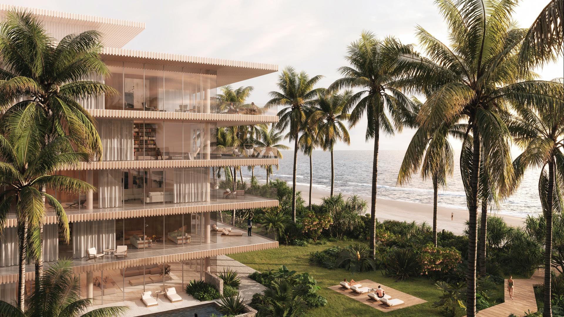 Palm Beach Residences by Aman in Palm Beach, Florida, oceanfront villa-style building among palm trees with glass walls, lawn sun deck and beach access, highlighting luxury and ultra luxury preconstruction condos and residences.