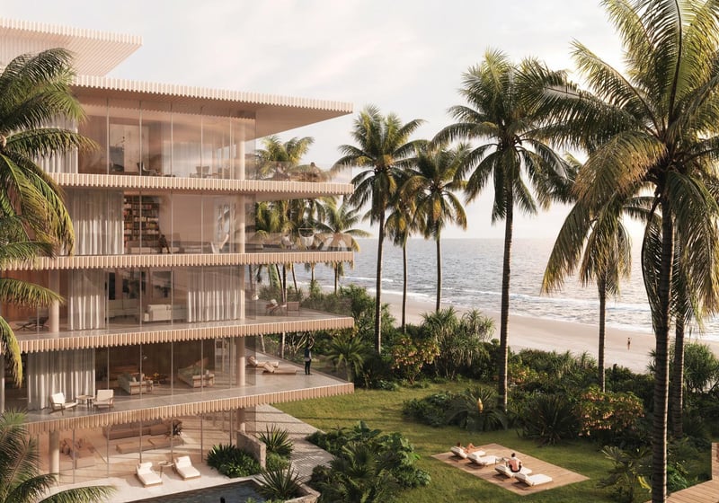 Palm Beach Residences by Aman in Palm Beach, Florida, oceanfront villa-style building among palm trees with glass walls, lawn sun deck and beach access, highlighting luxury and ultra luxury preconstruction condos and residences.