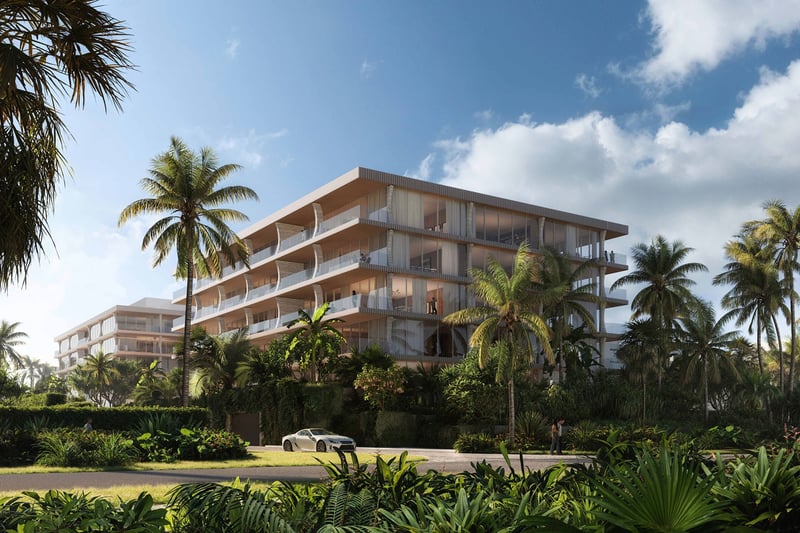 Palm Beach Residences by Aman, Palm Beach, Florida, modern beachfront condo exterior framed by lush gardens and palm trees with private drive, promoting luxury and ultra luxury preconstruction condos in a tropical setting.