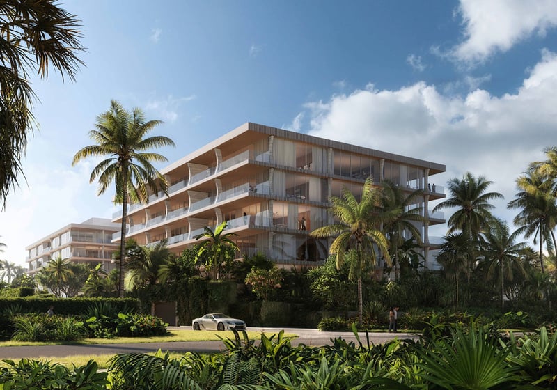 Palm Beach Residences by Aman, Palm Beach, Florida, modern beachfront condo exterior framed by lush gardens and palm trees with private drive, promoting luxury and ultra luxury preconstruction condos in a tropical setting.