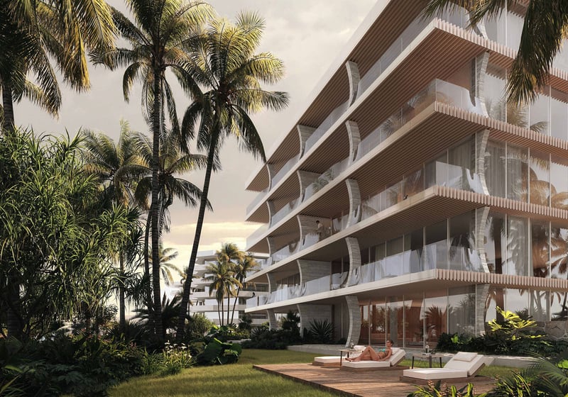 Palm Beach Residences by Aman in Palm Beach, Florida, resort-style grounds with palms, glass-fronted residences and sun deck lounge, highlighting luxury and ultra luxury preconstruction condos with serene tropical landscaping.