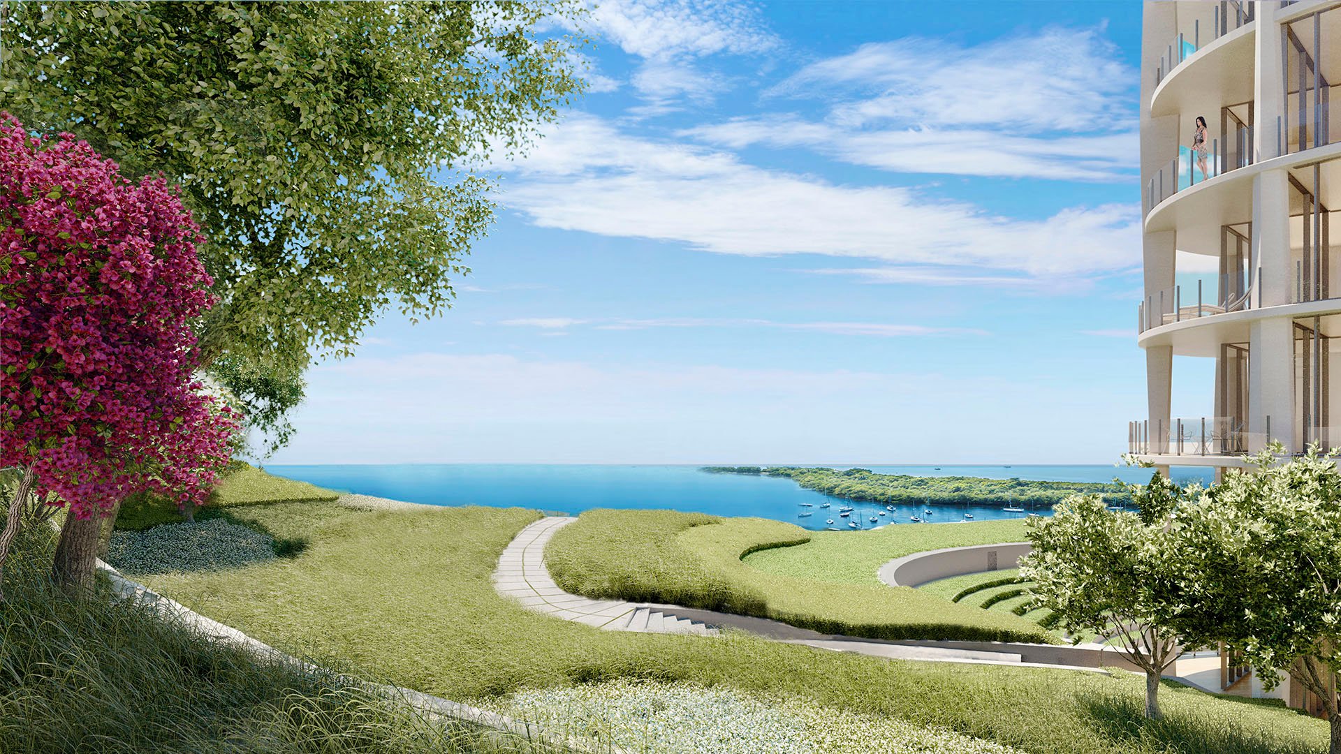 Bayfront bluff lawn with a curving path, flowering trees and a tower edge at Park Grove in Coconut Grove, shaping the landscape around the luxury and ultra luxury condos.