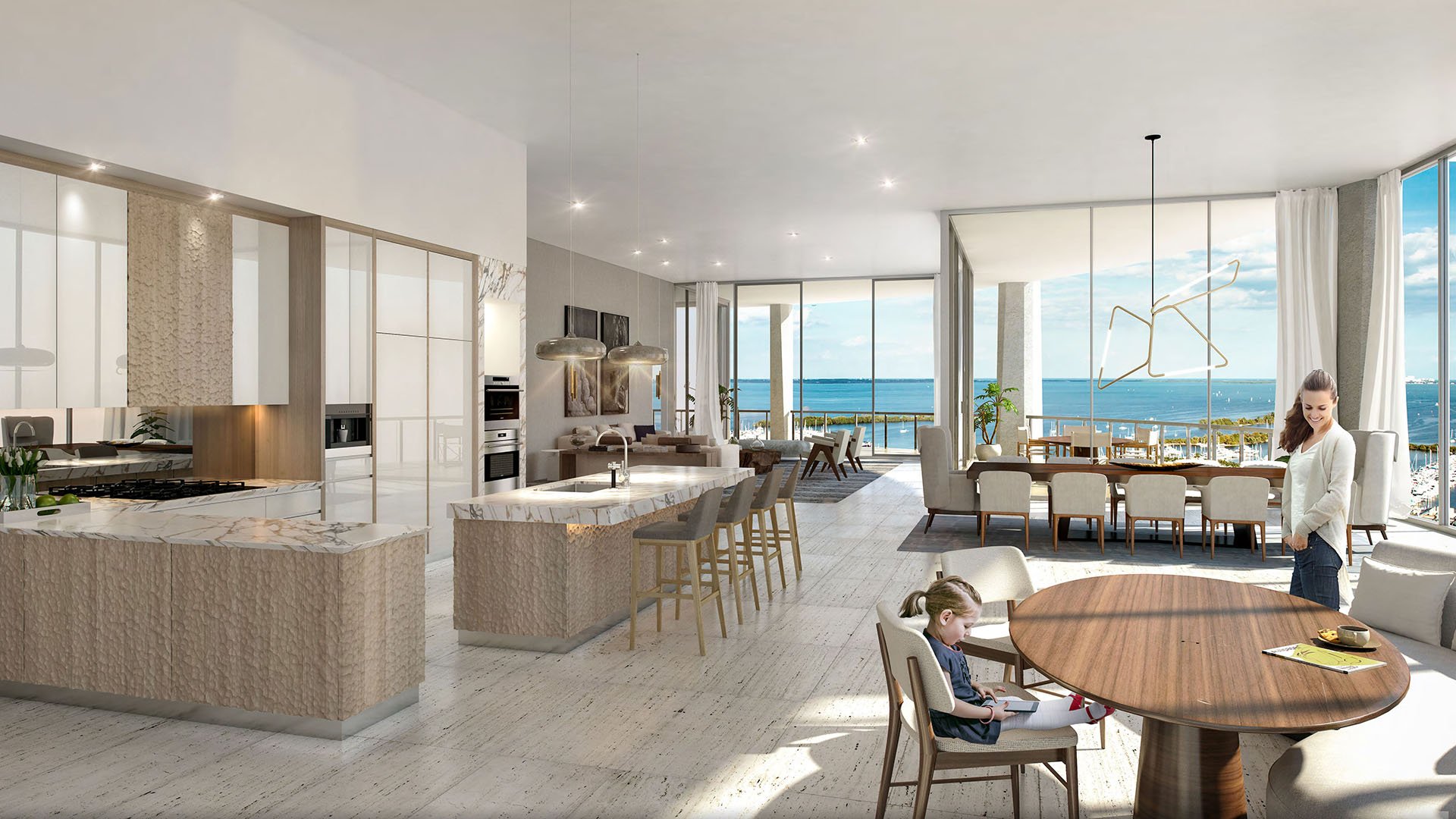 Family kitchen with double islands, multiple dining areas and sweeping bay views at Park Grove in Coconut Grove, illustrating spacious luxury and ultra luxury condos interiors.