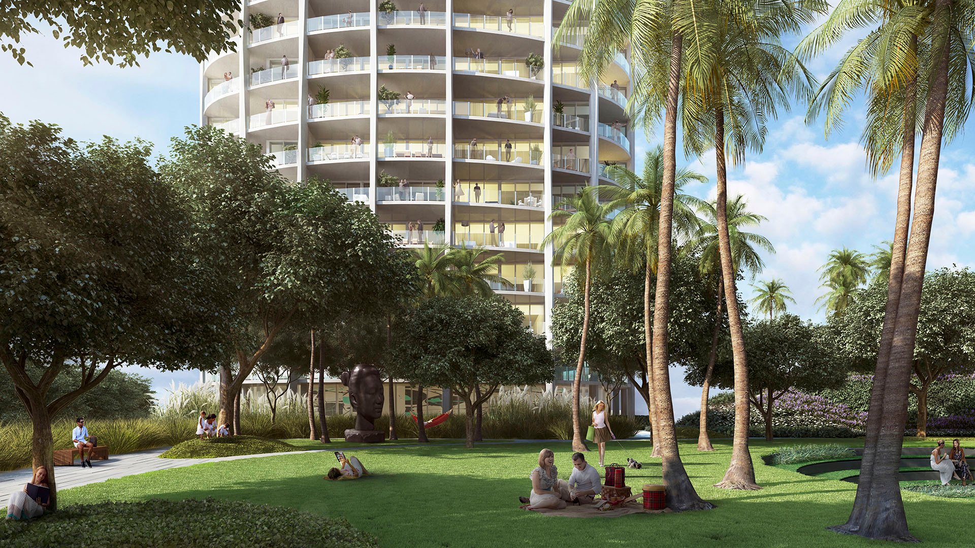 Palm garden lawn beneath a curved tower with shaded seating, sculpture and open green space at Park Grove in Coconut Grove, enriching the luxury and ultra luxury condos grounds.