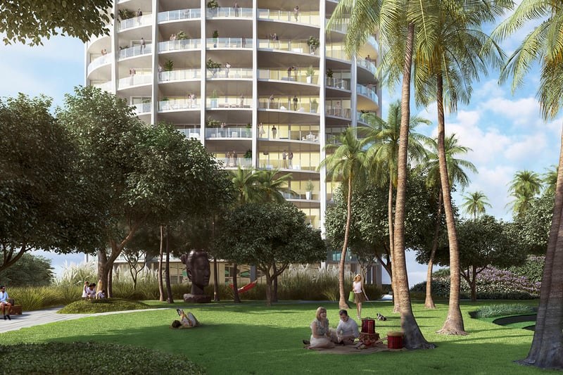 Palm garden lawn beneath a curved tower with shaded seating, sculpture and open green space at Park Grove in Coconut Grove, enriching the luxury and ultra luxury condos grounds.