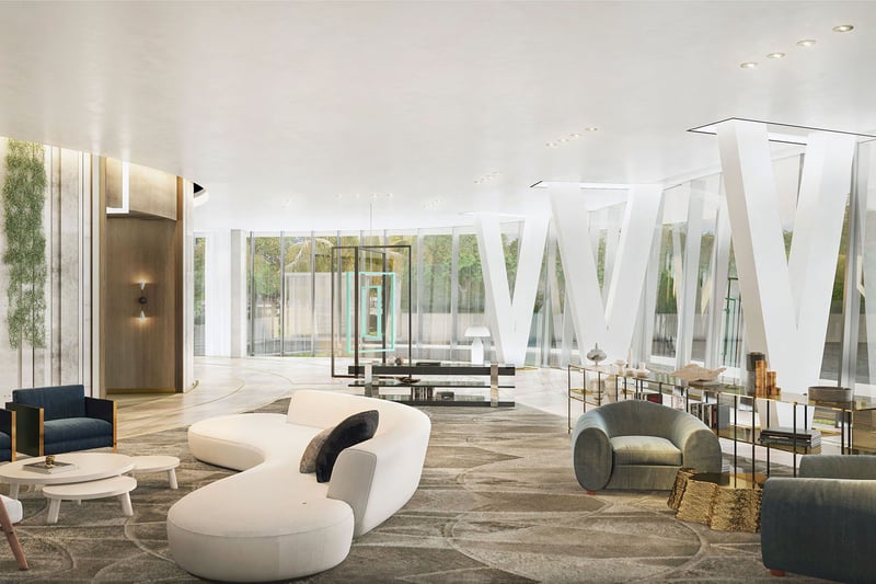 Sculptural white lobby lounge with angled columns, curved seating and glass walls at Park Grove in Coconut Grove, showcasing luxury and ultra luxury condos.