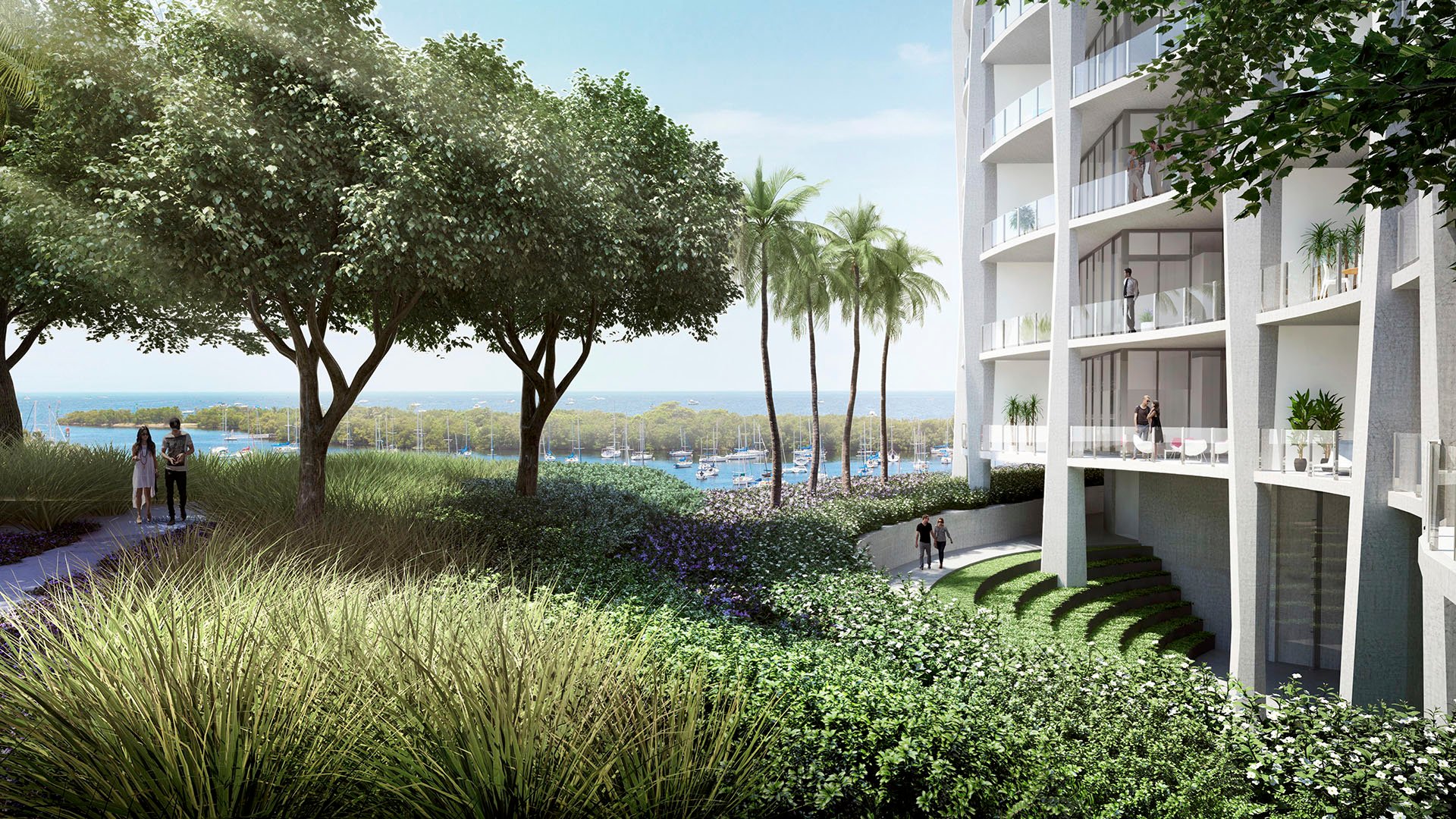 Waterfront garden path beside the tower with palms, layered planting and marina views at Park Grove in Coconut Grove, surrounding the luxury and ultra luxury condos.