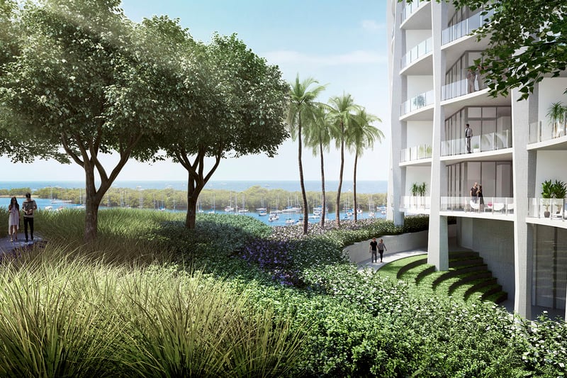 Waterfront garden path beside the tower with palms, layered planting and marina views at Park Grove in Coconut Grove, surrounding the luxury and ultra luxury condos.