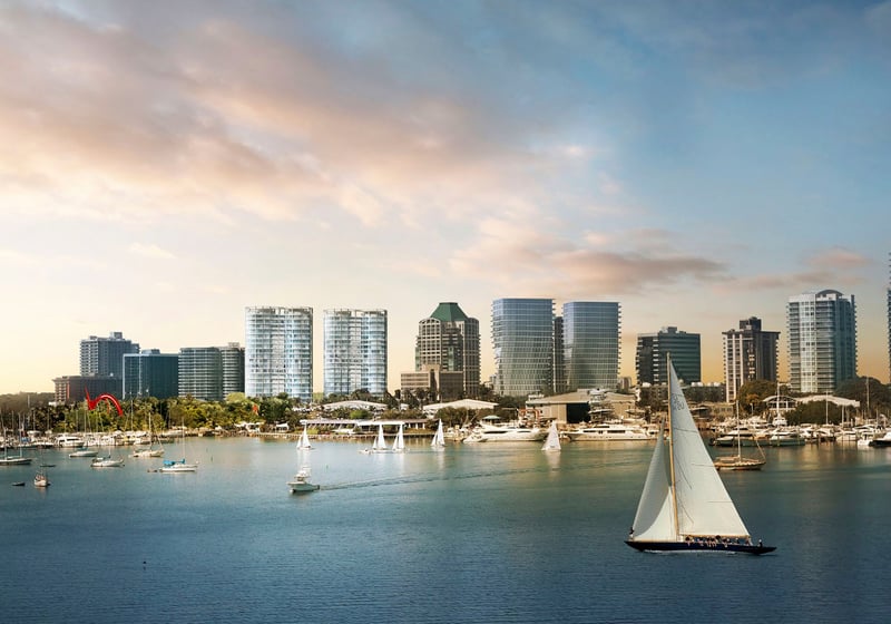 Waterfront skyline view with marinas, sailboats and a prominent sailboat in the foreground near Park Grove in Coconut Grove, framing the luxury and ultra luxury condos setting.