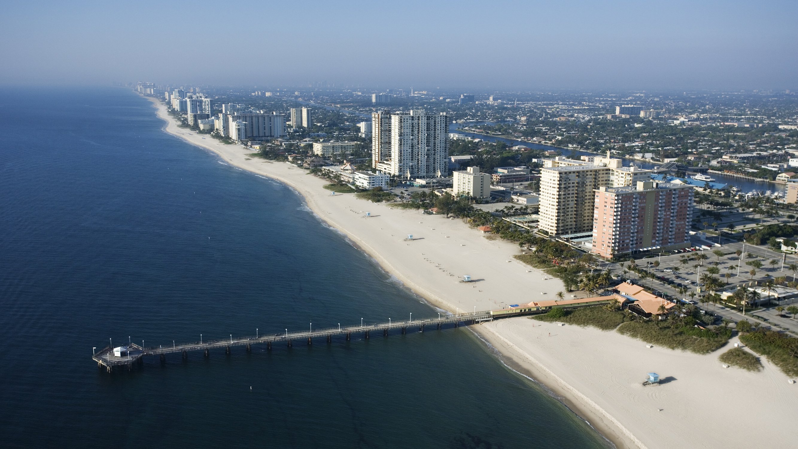 Pompano Beach, Florida aerial of beachfront cityscape, piers and high‑rises, growing hub for luxury and ultra luxury condos; preconstruction and resale. Featuring view.