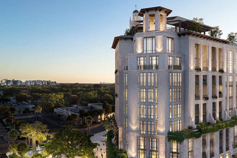 Ponce Park Residences in Coral Gables, Miami aerial corner view at golden hour with rooftop terraces and skyline backdrop, showcasing luxury and ultra luxury preconstruction condos with elegant illuminated facade.