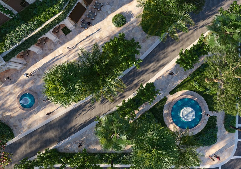Top-down aerial of Ponce Park Residences entry paseo in Coral Gables, Miami with palm trees, stone walkways and fountains, representing luxury and ultra luxury preconstruction condos with resort-style arrival.