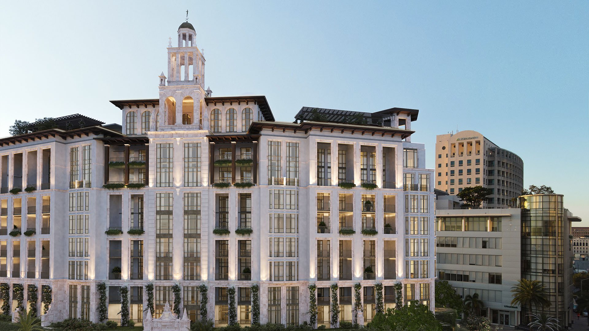 Ponce Park Residences Coral Gables, Miami exterior facade at dusk featuring Mediterranean-inspired architecture and signature tower, promoting luxury and ultra luxury preconstruction condos in downtown Coral Gables.