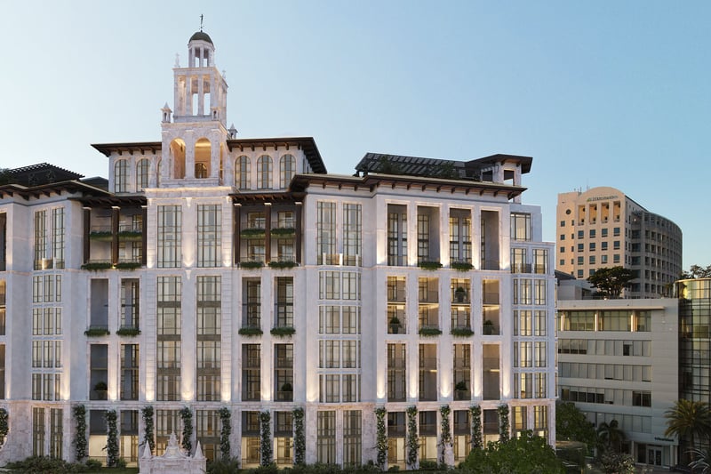 Ponce Park Residences Coral Gables, Miami exterior facade at dusk featuring Mediterranean-inspired architecture and signature tower, promoting luxury and ultra luxury preconstruction condos in downtown Coral Gables.