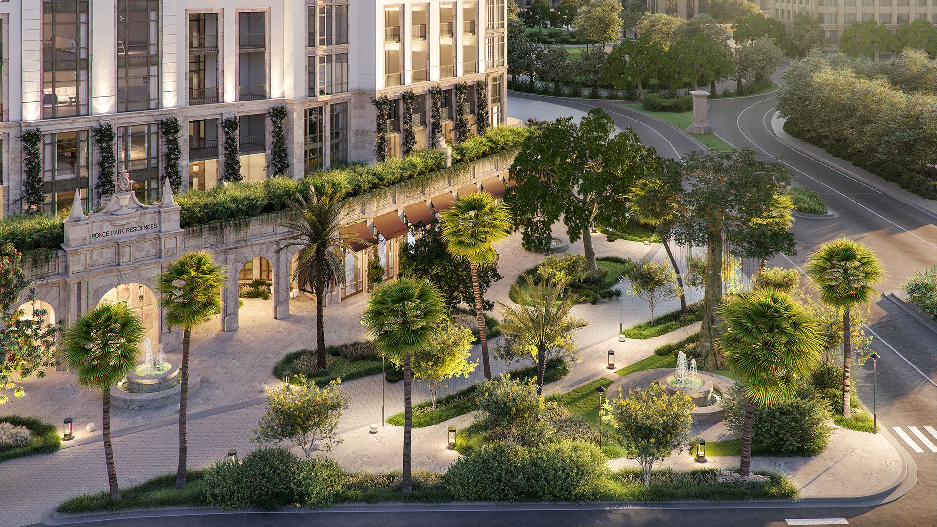 Landscaped street-corner entry at Ponce Park Residences Coral Gables, Miami with stone arches, palms and fountains, showcasing luxury and ultra luxury preconstruction condos and grand arrival courtyard.
