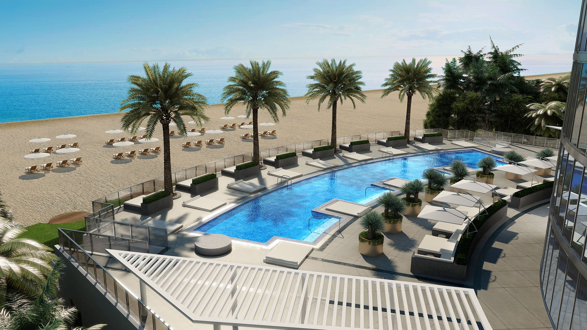 Porsche Design Tower Sunny Isles Beach luxury ultra luxury condos with a beachfront pool terrace, sun deck seating, palm trees, and expansive Atlantic Ocean views in Sunny Isles Beach.
