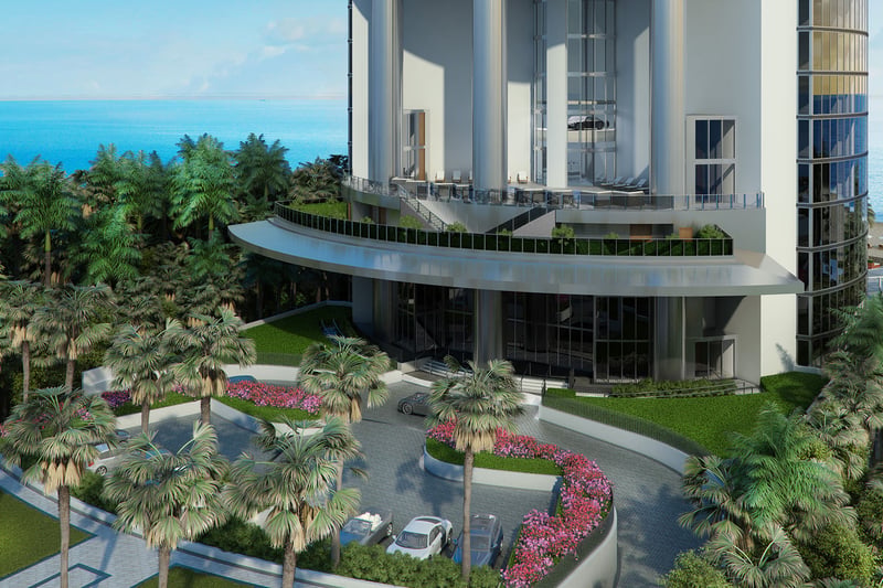 Porsche Design Tower Sunny Isles Beach luxury ultra luxury condos with a grand curved exterior entrance, tropical landscaping, porte cochere driveway, and oceanfront setting in Sunny Isles Beach.
