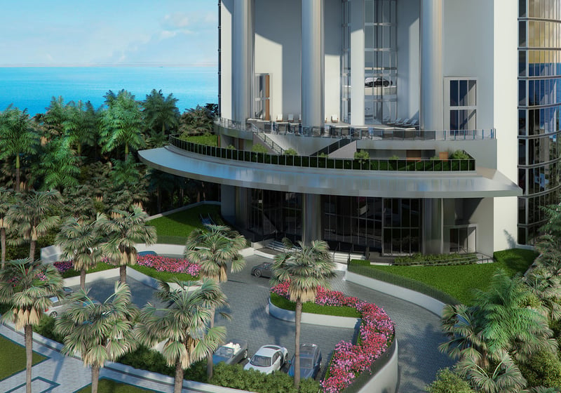 Porsche Design Tower Sunny Isles Beach luxury ultra luxury condos with a grand curved exterior entrance, tropical landscaping, porte cochere driveway, and oceanfront setting in Sunny Isles Beach.