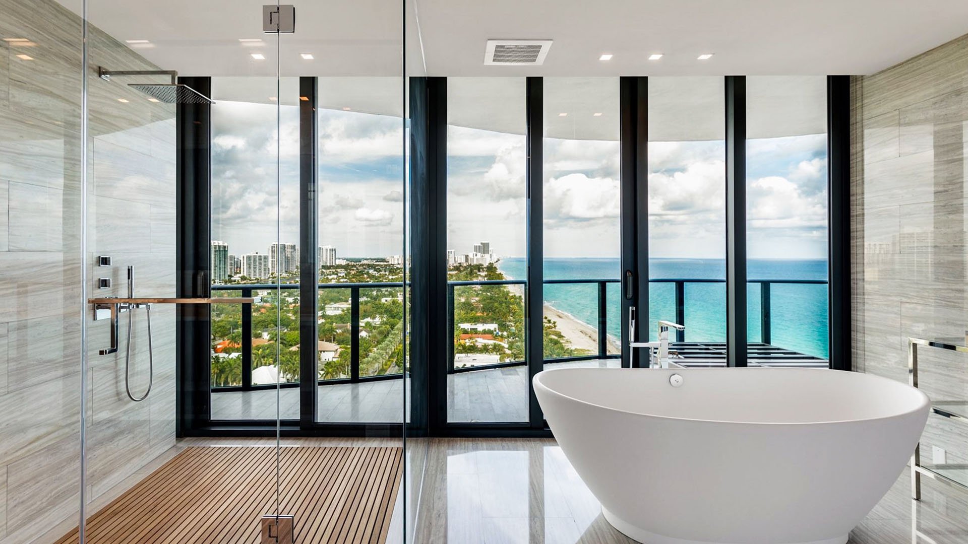 Spa bathroom at Regalia in Sunny Isles Beach with a freestanding tub, glass shower, and wide water views inside luxury and ultra luxury condos.