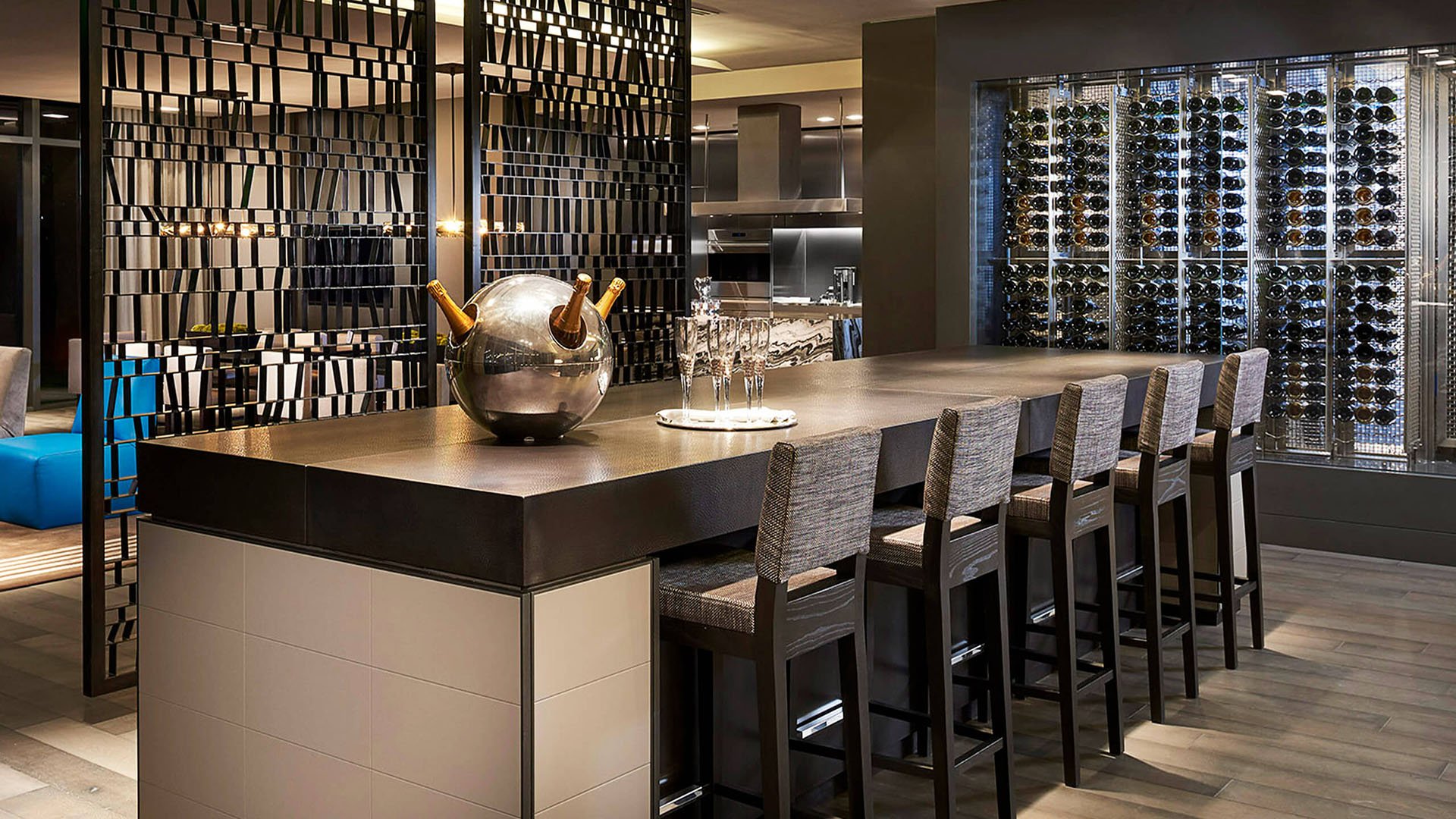 Wine tasting bar at Regalia in Sunny Isles Beach with a large communal counter and glass wine cellar serving luxury and ultra luxury condos.